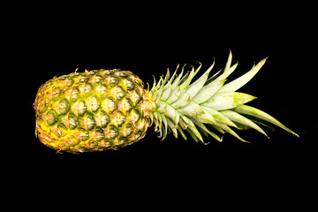 pineapple lies on a black background