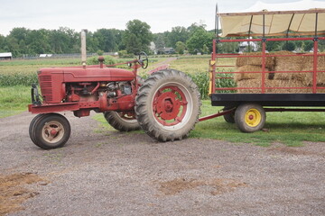 Red Fsrm Tractor Pulling Load of Hay