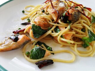 Spaghetti on black plate on wooden background. top view.