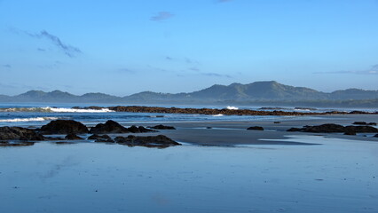 Sunrise on the beach in Tamarindo, Costa Rica, with mountains in the distance