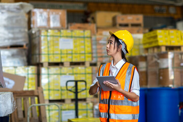 Woman worker working in warehouse. Industrial and industrial workers concept. worker woman order details and checking goods and Supplies.