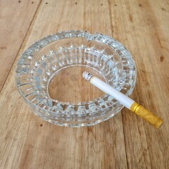 pack of cigarettes and glass ashtray