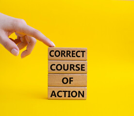 Correct course of action symbol. Concept words Correct course of action on wooden blocks. Beautiful yellow background. Businessman hand. Business and Correct course of action concept. Copy space.