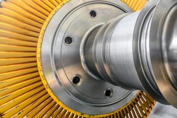 Part of powerful steam turbine with yellow blades at plant © nordroden