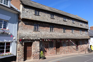 The old Nunnery in Dunster, Somerset dates back to the 15th century and is a terrace of three houses, three storeys tall, built of stone with a slate roof.