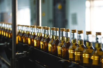 Alcohol liquor closed bottles with caps at production line