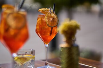 Cold and refreshing aperol spritz cocktail on table in cafe The perfect summer drink.
