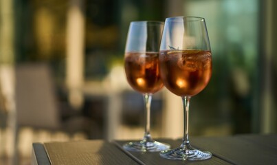Champagne based cocktail in wine glass on table.