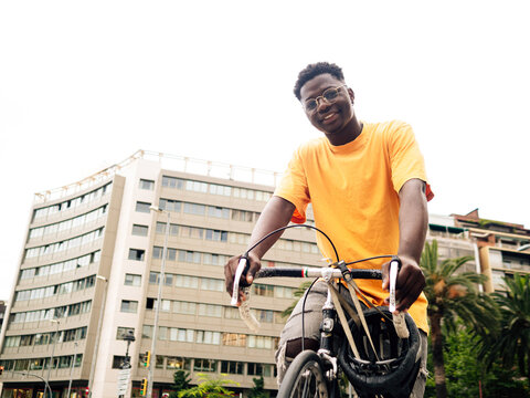 African American young man with a bicycle in the city. Sustainable mobility, millennial lifestyle