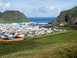 Fototapeta na wymiar Panoramic view of Heimaey town and harbor on Heimaey Island - Westman Islands, Iceland