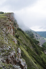 Fog on the top of the mountain, the nature of Russia, the rock Uklykaya Bashkortostan, a beautiful mountain peak, a steep cliff