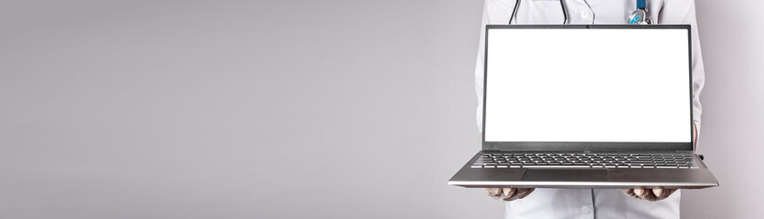 Banner with doctor holding laptop mockup. Online medical consultation, using computer at work and study, telehealth, telemedicine concept. Copy space. High quality photo