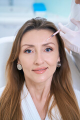 Patient undergoing forehead skin rejuvenation procedure with injections