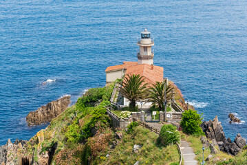 Fototapeta na wymiar Cudillero Lighthouse, in Punta Roballera, overlooking the Cantabrian Sea, Asturias.