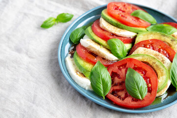 Homemade Organic Avocado Caprese Salad on a Plate, side view. Space for text.