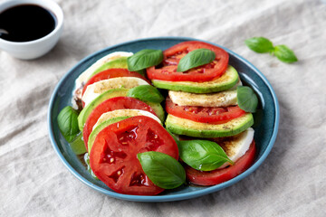 Homemade Organic Avocado Caprese Salad on a Plate, low angle view.