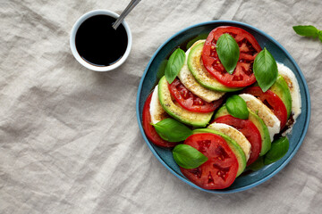 Homemade Organic Avocado Caprese Salad on a Plate, top view. Flat lay, overhead, from above.
