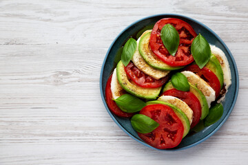 Homemade Organic Avocado Caprese Salad on a Plate, top view. Flat lay, overhead, from above. Space for text.