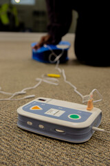 Security guard conducting CPR first aid with the AED.