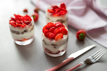 delicious homemade dessert with cream and strawberries in a glass