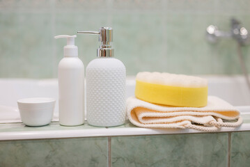Obraz na płótnie Canvas bath accessories liquid soap dispenser with washcloth and cream