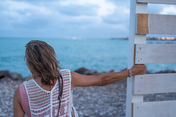 Mujer mirando el horizonte disfrutauna tarde en la playa