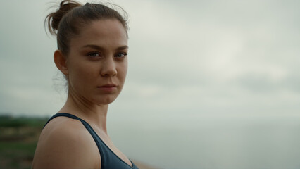 Profile girl turning face to camera confidently close up. Woman practicing yoga.