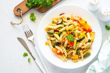 Vegan pasta with vegetables. Healthy vegetarian dish. Top view on white.
