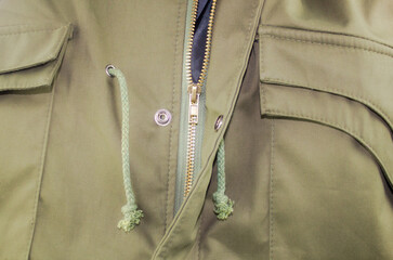 Men's green jacket. Men's jacket design close-up. Fabric and tailoring of a men's jacket. Fashionable modern men's clothing.