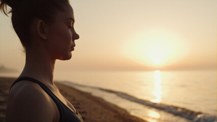 Profile sportswoman making meditation exercise on beach cposeup. Harmony concept