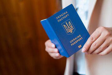 a girl holds a passport of ukraine in her hands