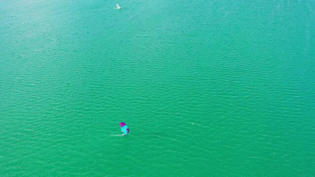 windsurf and kitesurf boards sailing on a lake. Aerial view. 4K. Alloz reservoir, Navarra, Spain, Europe.