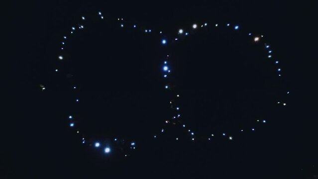 Flash mob figure 8, people waving flashlights, aerial photography