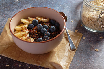 Chocolate banana oatmeal, with ground flaxseed and blueberries