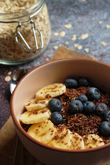 Chocolate banana oatmeal, with ground flaxseed and blueberries