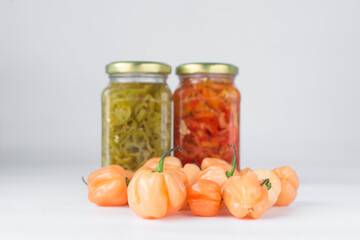 A scotch bonnet pepper with stem on a white background, fresh pepper, orange coral pepper, Nigerian scotch bonnet pepper