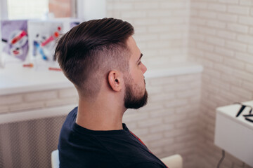 
Male head with stylish haircut on barbershop background
