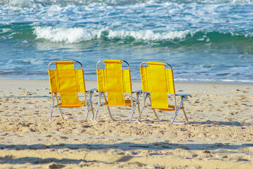 yellow beach chair at leblon beach in Rio de Janeiro, Brazil.