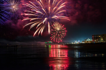 Fireworks at the old pier on the ocean on Independence Day USA. USA. Maine. Old Orchard Beach.