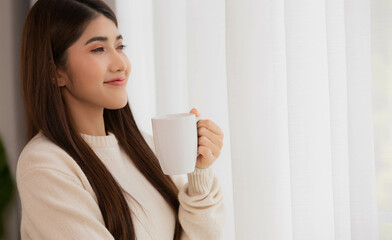 Asian woman take a cup of coffee and have a drink on a relaxing in morning