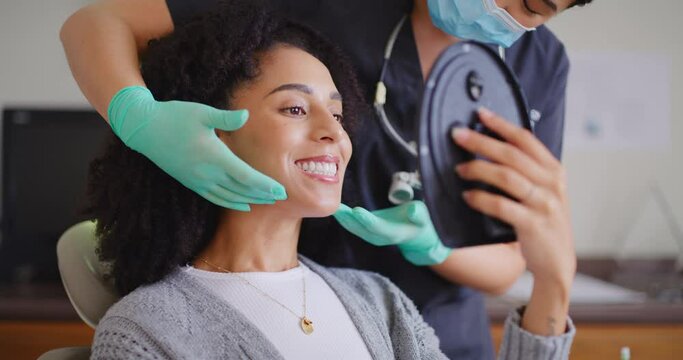Dentist showing female patient mirror to check her teeth after whitening at dental appointment. Woman having checkup to prevent tooth decay and gum disease. Good oral hygiene for healthy teeth