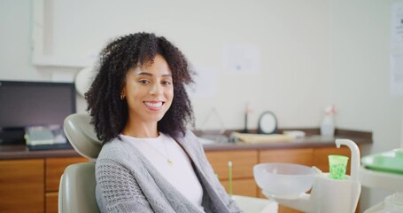 Young woman sitting in dentist chair with perfect teeth with copy space. Happy patient confident with her oral hygiene whitening service during dentistry orthodontist appointment at a medical clinic