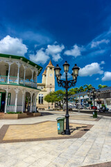 Fototapeta na wymiar Central Park of Puerto Plata, Dominican Republic featuring ancient Cathedral, City Hall, multiple historical buildings and famous landmarks - July 2, 2022.