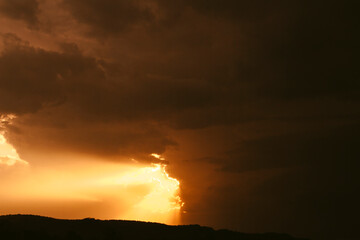 sunset peeking through the clouds