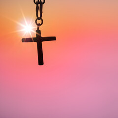 Silhouette of christian cross and chain