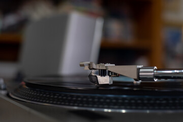 Fototapeta na wymiar The Headshell Cartridge and Stylus of Classic Vintage Vinyl Record Player Playing on Vinyl Record Music