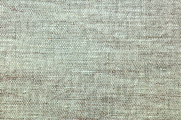 Fototapeta na wymiar beige crumpled flax fabric texture. highly detailed pattern. closeup view.