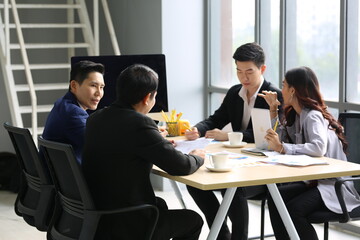 Businessman Giving Speech On Business Meeting With Colleagues, Discussing Work Ideas And Projects, Making Presentation Standing In Modern Office. Teamwork, Entrepreneurship, Corporate Meeting
