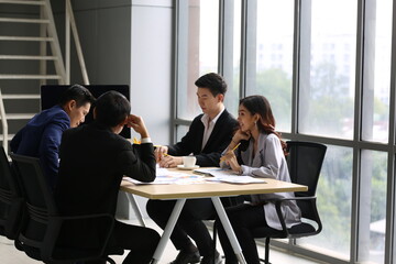 Businessman Giving Speech On Business Meeting With Colleagues, Discussing Work Ideas And Projects, Making Presentation Standing In Modern Office. Teamwork, Entrepreneurship, Corporate Meeting