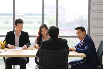 Businessman Giving Speech On Business Meeting With Colleagues, Discussing Work Ideas And Projects, Making Presentation Standing In Modern Office. Teamwork, Entrepreneurship, Corporate Meeting
